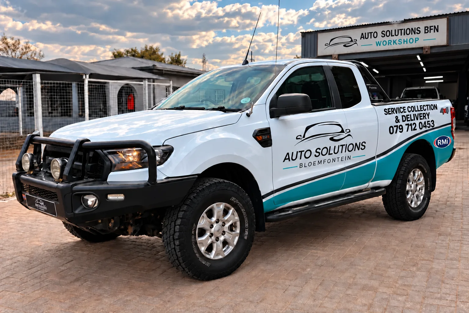 Ford Ranger concept with Auto Solutions door emblem, collection and delivery lettering, and a workshop advertising board