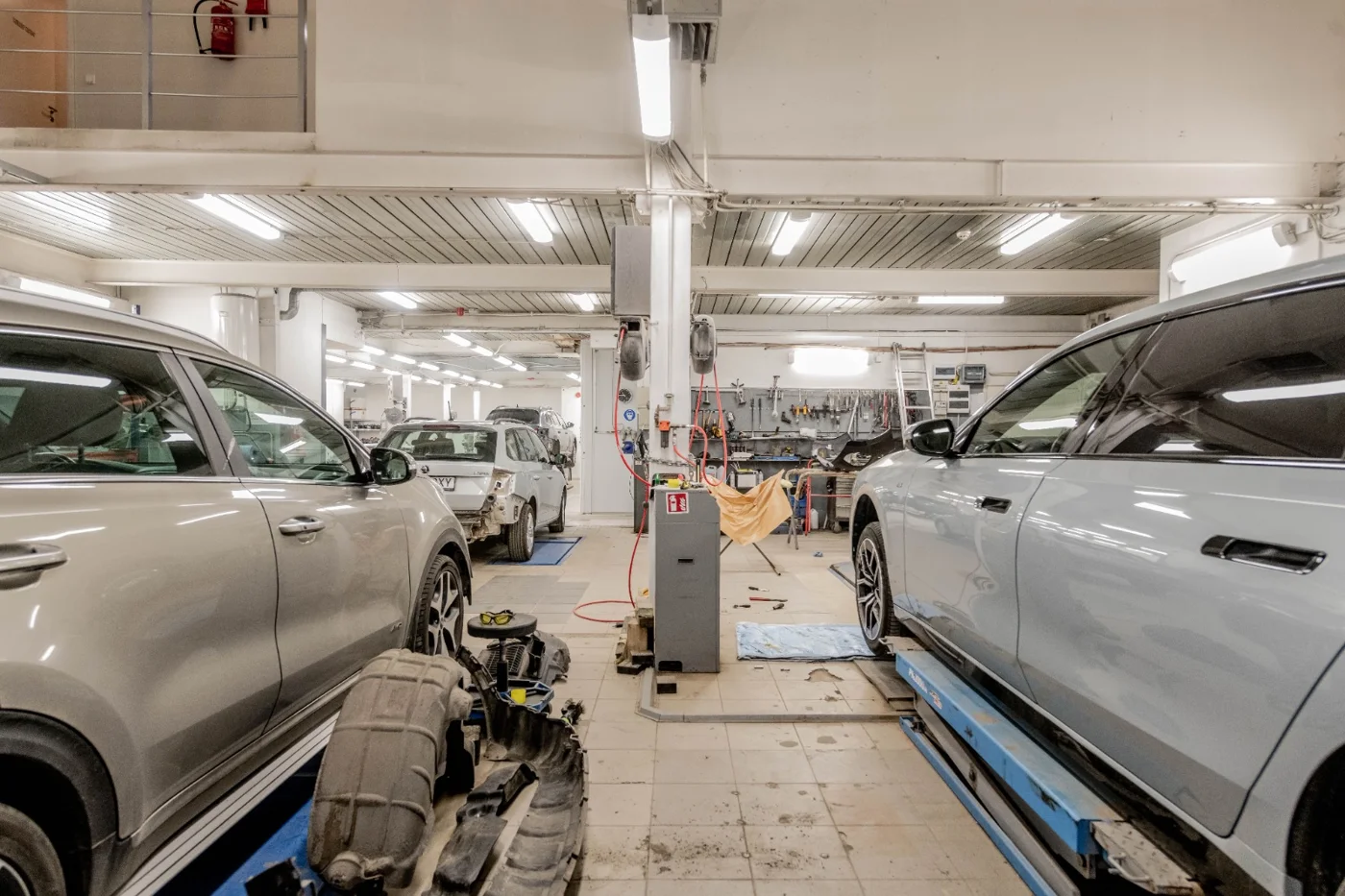 Vehicles in a bright workshop service bay
